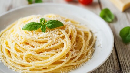 A delicious serving of spaghetti topped with cheese and fresh basil, set on a rustic wooden table.