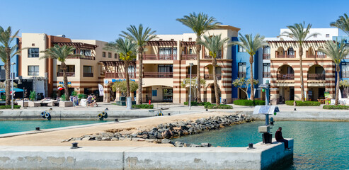 Elegant residential buildings and rocky shore in the Port Ghalib marina, Egypt 10 March 2025