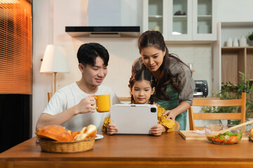 Family Asian spending happy time together on vacation, sitting in the kitchen.