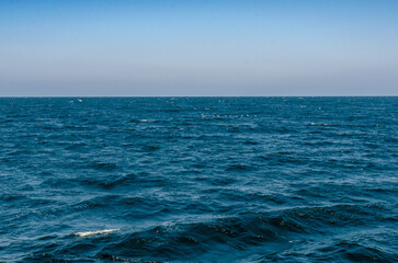Obraz premium Wide view of the Red Sea from a boat in Port Ghalib, Egypt. Deep blue water and open horizon. March 4, 2025.