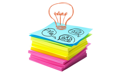 Creative brainstorming session with ideas on sticky notes office workspace digital art bright colors top view