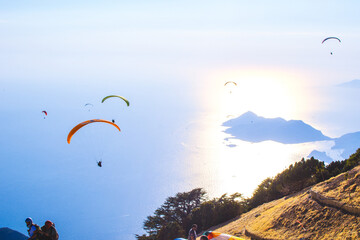 Paragliders over sunset sea and islands from Babadag Mountain in Oludeniz Turkey 19 August 2024