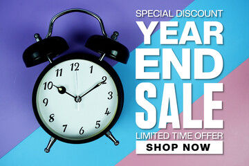 Year End Sale text with Alarm clock on blue, purple and pink geometric background