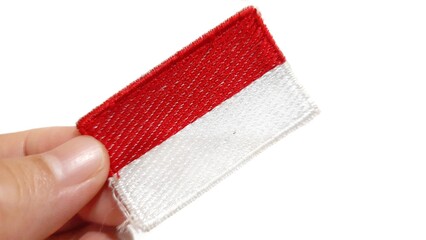 Hand Holding an Indonesian Flag Patch. Happy Anniversary Independence Day of Indonesia, August 17Th...