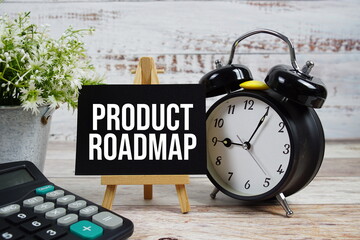 Product Roadmap text with alarm clock and calculator on wooden background