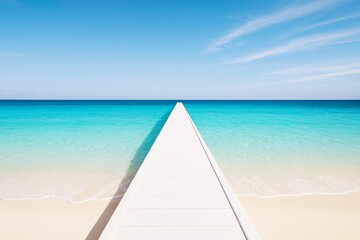 Fototapeta premium Endless white pier leading into turquoise ocean under clear blue sky on sunny day, travel and freedom concept background.