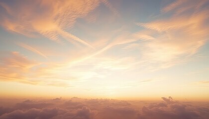 Obraz premium Serene vista of fluffy clouds bathed in the warm glow of sunrise with wispy contrails streaking across the vast expanse