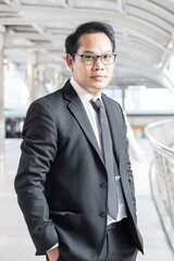 Portrait of a businessman leader in a suit standing outside a building