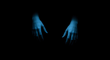  Two glowing blue hands dangling in darkness, evoking mystery and unease.