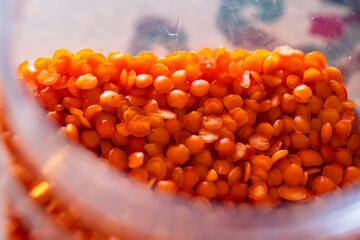 Close-up of red lentils in a glass jar.  Storage concept