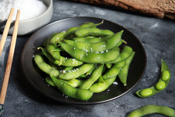 Green soybeans or Edamame in black plate. Healthy snack and side dish in Asian food