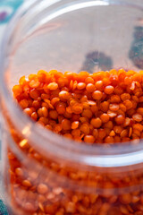 Close-up of red lentils in a glass jar.  Storage concept
