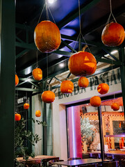 Hanging pumpkins create a festive atmosphere in an evening courtyard setting