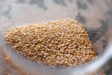 Close-up of raw quinoa in a glass jar. Superfood. Storage concept