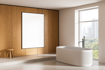 Modern bathroom interior with white bathtub and large vertical blank poster on wooden wall in clean...