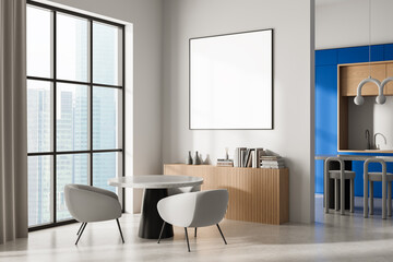 Modern interior with blank framed poster on white wall above wooden cabinet in bright room with dining space and city view through large windows. 3D Rendering