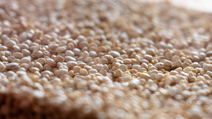 Close-up of raw quinoa in a glass jar. Superfood. Storage concept