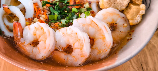 Noodles with seafood in an orange plate