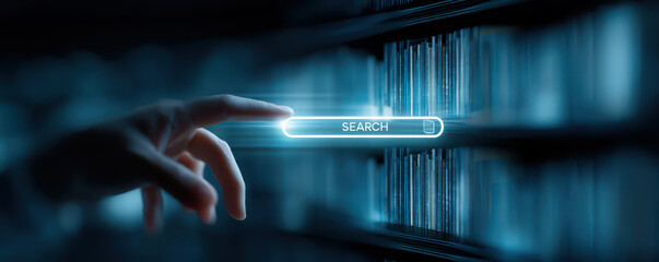 Hand reaching towards digital search interface over blurred library shelves, symbolizing technology and information retrieval