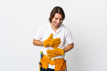 Young electrician man over isolated background smiling a lot