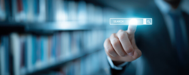 Business professional interacting with a digital search bar in a library filled with books and knowledge resources