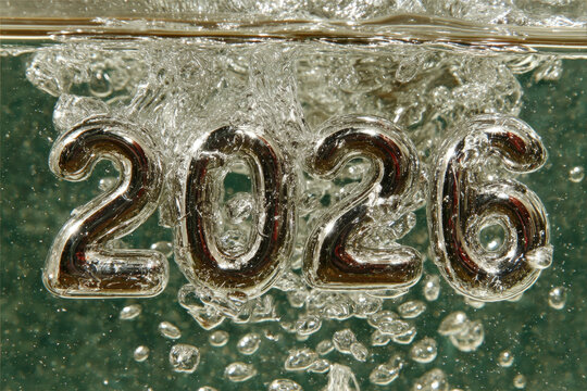 Shiny liquid metal numbers morphing into 2026 in zero gravity chamber