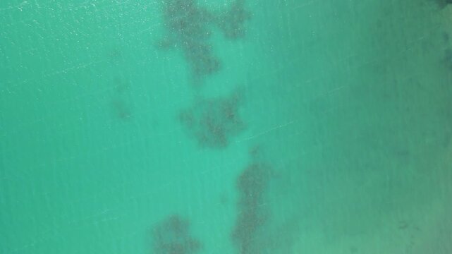 Close-up view of Lake Balkhash water surface. The vivid blue-green hues reflect sunlight, showing the lake&rsquo;s clarity and unique coloration. 