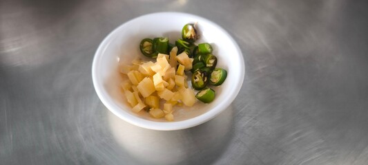 Sliced ??chilli and ginger in a white bowl