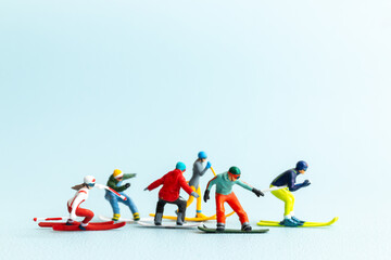 Miniature figurines of skiers and snowboarders posed in a dynamic winter sports lineup