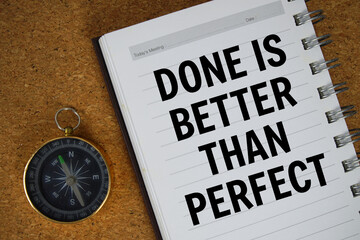 Done Is Better Than Perfect text written on notebook paper with compass