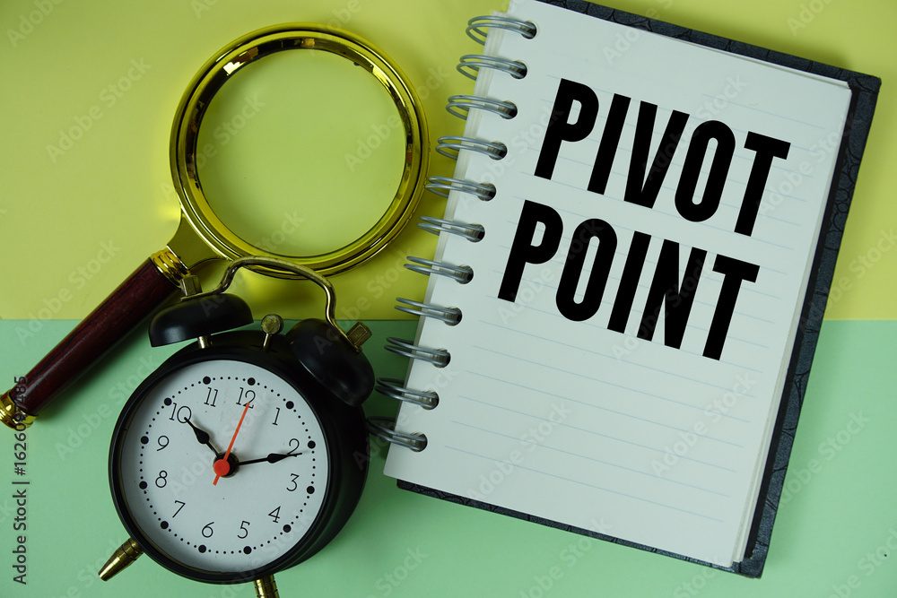 Aufkleber pivot point text written on notebook paper with magnifying glass and alarm clock