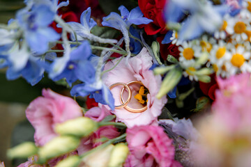 Wedding Rings Lying on Colorful Flowers