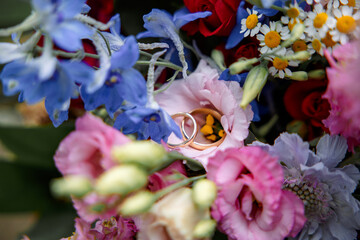 Wedding Rings Lying on Colorful Flowers