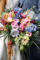 Bride and Groom Holding Wedding Bouquet Together