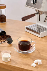 Espresso Coffee Preparation Delicious Drink with Modern Espresso Machine, Coffee machine and cup of coffee on a wooden table.