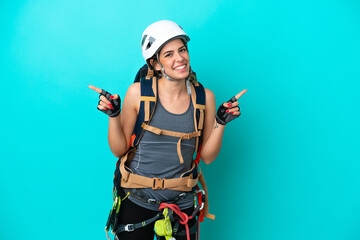 Young Italian rock-climber woman isolated on blue background pointing finger to the laterals and...