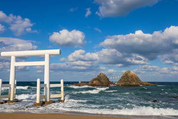 Sacred Meotoiwa Rocks and Ocean View with Japanese Shinto Torii Gate on the Beach