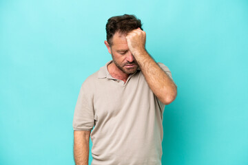 Middle age caucasian man isolated on blue background with headache