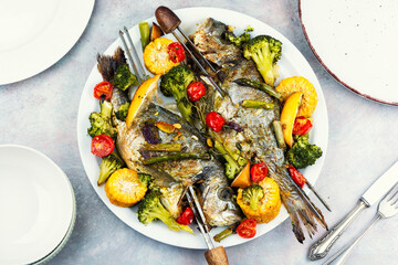 Roasted Dorada fish with vegetables.