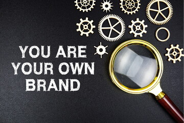 You Are Your Own Brand text message with magnifying glass on black background