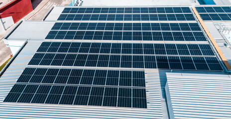 Energy efficient rooftop with multiple solar panels installed on a contemporary mall