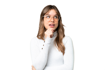 Young girl over isolated chroma key background With glasses and thinking while looking up