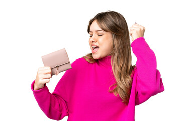 Young girl holding a wallet over isolated chroma key background celebrating a victory