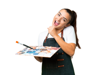 Young artist woman holding a palette over isolated chroma key background celebrating a victory