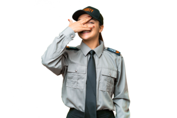 Young safeguard woman over isolated chroma key background covering eyes by hands and smiling