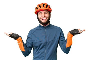Young cyclist man over isolated chroma key background with shocked facial expression