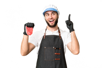 Butcher man wearing an apron and serving fresh cut meat over isolated chroma key background thinking an idea pointing the finger up
