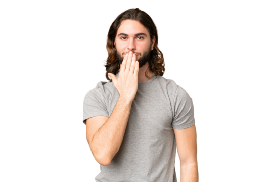 Young handsome man over isolated chroma key background covering mouth with hand