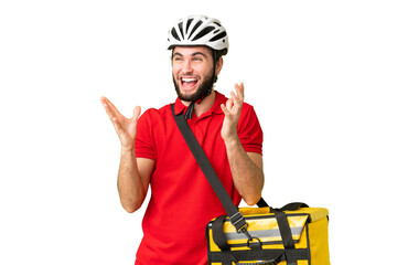 Young delivery man with thermal backpack over isolated chroma key background with surprise facial...