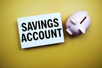 Savings Account text and piggy bank for saving on yellow background